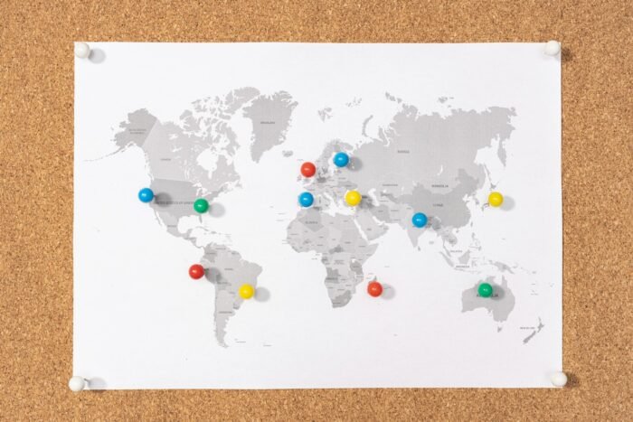 Pushpins on world map on Corkboard